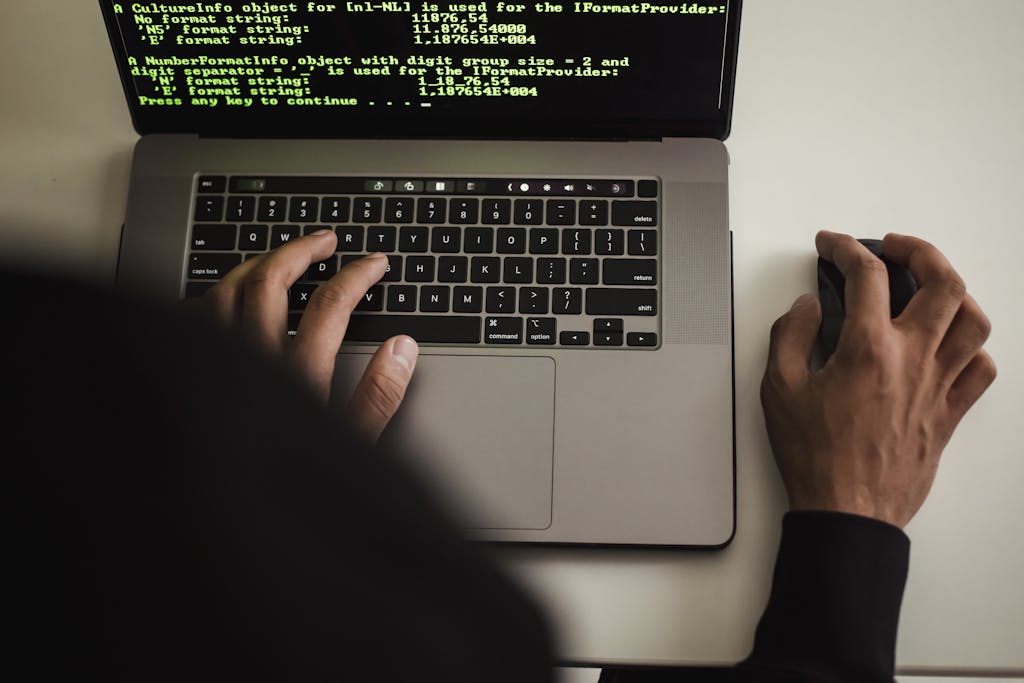 Crop faceless programmer working on laptop in studio