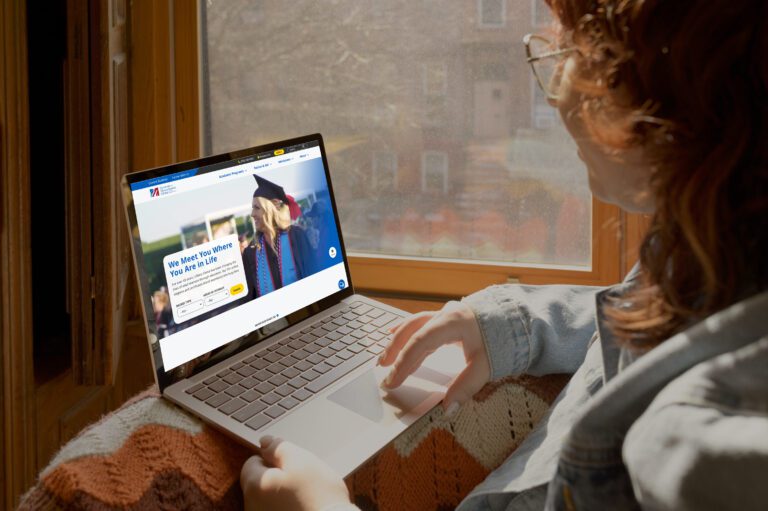 woman using umass website on laptop