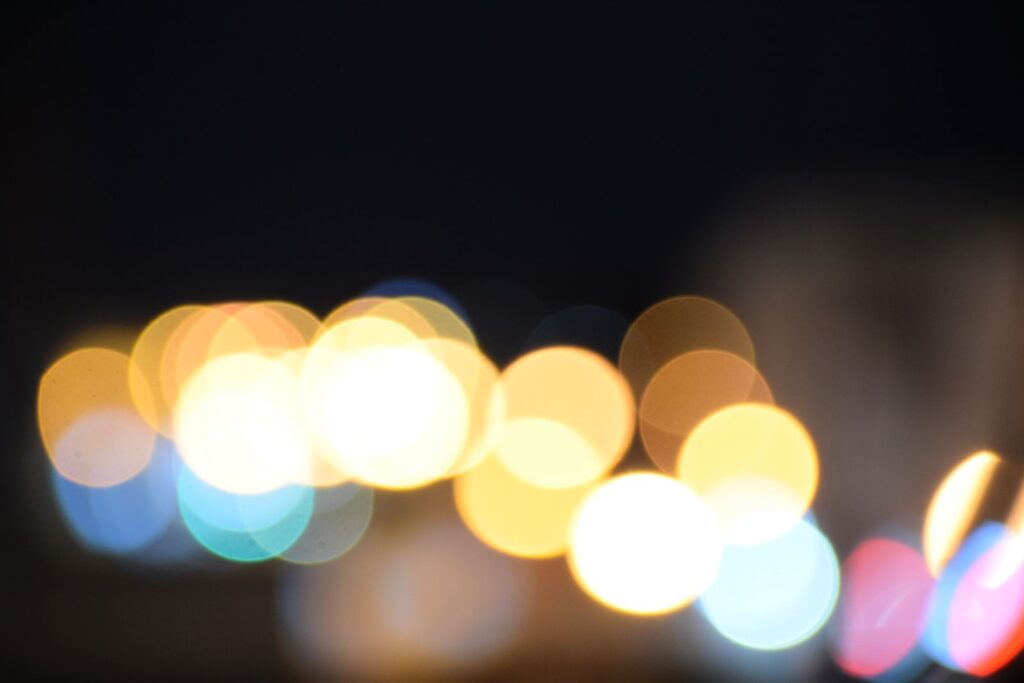 Out-of-focus city lights forming colorful bokeh circles against a dark background